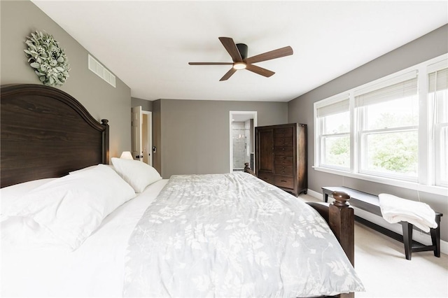 74 Broadmoor Trl, Perinton, NY 14450 - bedroom with light colored carpet, ensuite bath, a ceiling fan, and baseboards