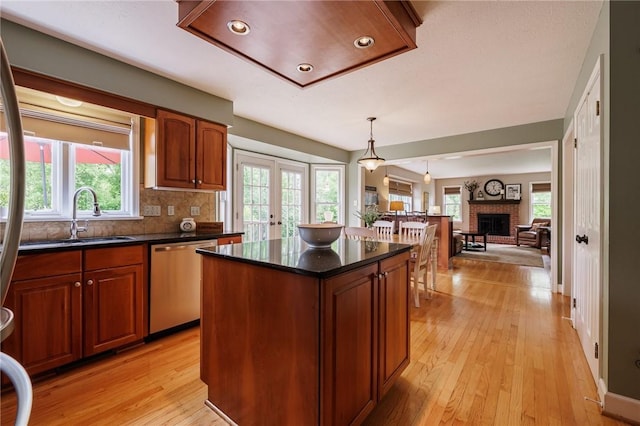 74 Broadmoor Trl, Perinton, NY 14450 - kitchen with stainless steel dishwasher, a sink, a kitchen island, french doors, and light wood-style floors
