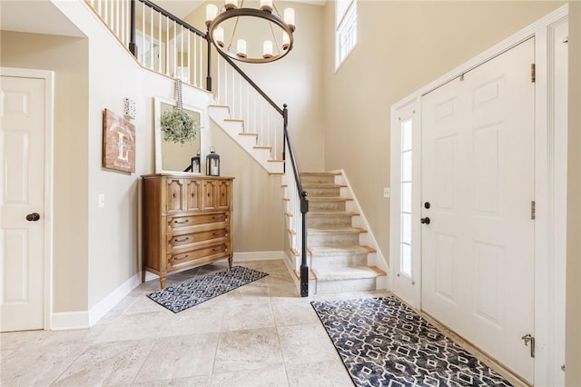 74 Broadmoor Trl, Perinton, NY 14450 - entrance foyer with stairway, a chandelier, baseboards, and a towering ceiling