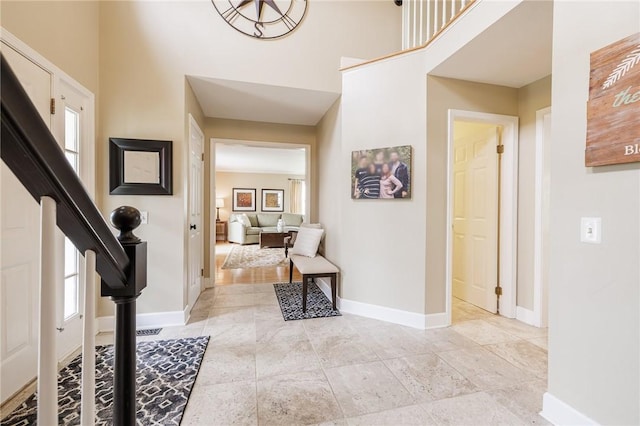 74 Broadmoor Trl, Perinton, NY 14450 - entryway with baseboards, stairway, and a towering ceiling