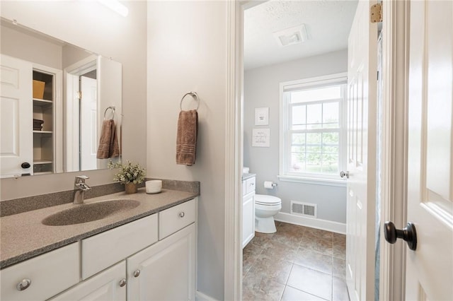 74 Broadmoor Trl, Perinton, NY 14450 - bathroom featuring toilet, vanity, baseboards, and tile patterned flooring