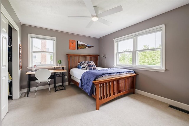 74 Broadmoor Trl, Perinton, NY 14450 - bedroom featuring multiple windows, light carpet, baseboards, and ceiling fan
