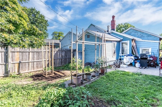110 10th St, Buffalo, NY 14201 - back of house with a patio and a chimney