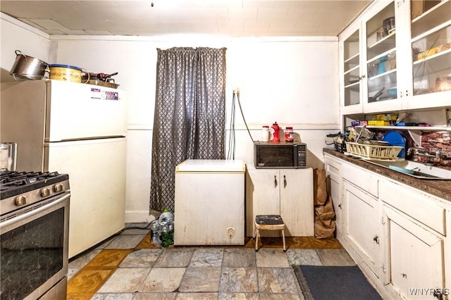110 10th St, Buffalo, NY 14201 - kitchen featuring black microwave, refrigerator, gas stove, a sink, and white cabinets