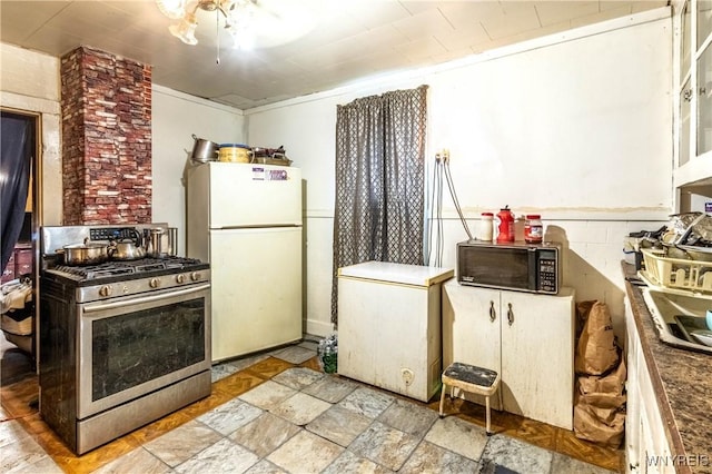 110 10th St, Buffalo, NY 14201 - kitchen featuring gas range, freestanding refrigerator, black microwave, and white refrigerator