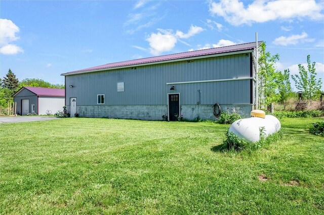 2309 Mcburney Rd, Phelps, NY 14432 - view of side of home with a lawn, a pole building, metal roof, and an outdoor structure