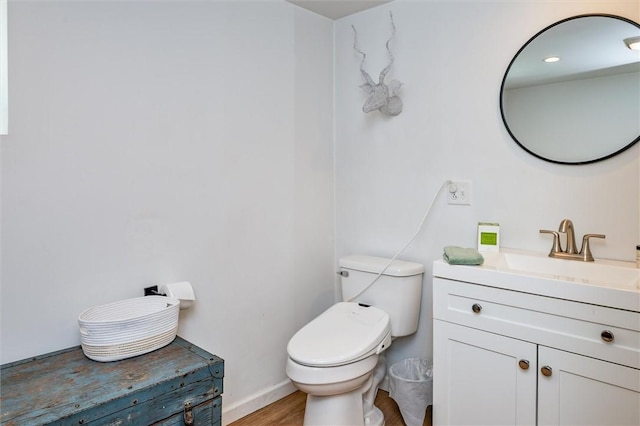 2309 Mcburney Rd, Phelps, NY 14432 - bathroom with vanity, toilet, baseboards, and wood finished floors