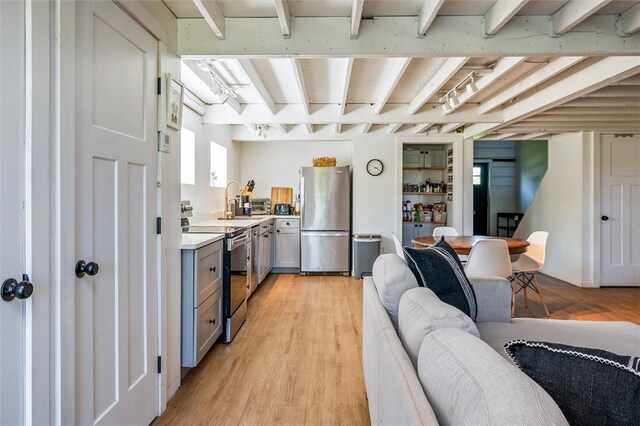 2309 Mcburney Rd, Phelps, NY 14432 - kitchen featuring stainless steel appliances, gray cabinets, light countertops, light wood-style flooring, and beam ceiling