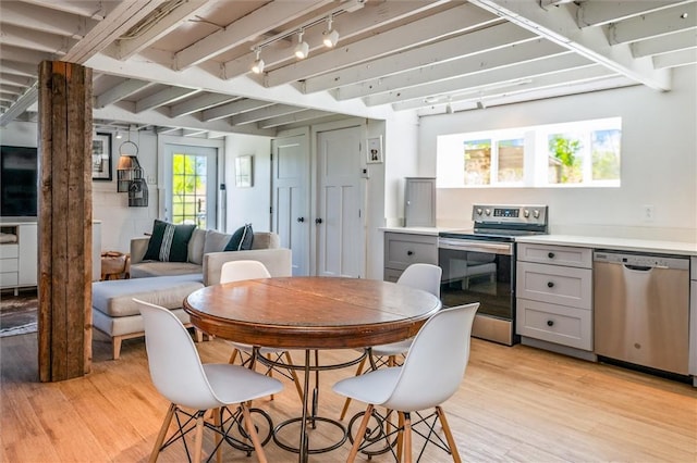 2309 Mcburney Rd, Phelps, NY 14432 - dining room featuring light wood-style flooring, beamed ceiling, and track lighting