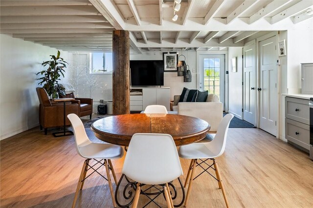 2309 Mcburney Rd, Phelps, NY 14432 - dining space with light wood-style floors, beamed ceiling, and baseboards