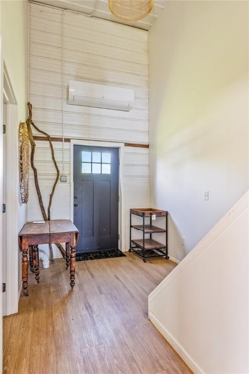 2309 Mcburney Rd, Phelps, NY 14432 - entryway featuring an AC wall unit and wood finished floors