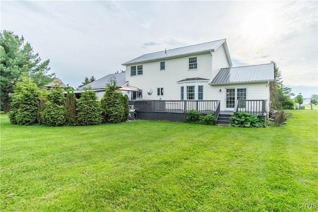 1 Carol Dr, Adams, NY 13605 - rear view of property with a metal roof, a yard, and a wooden deck
