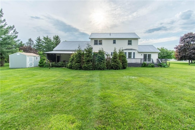 1 Carol Dr, Adams, NY 13605 - back of house with a storage shed, a metal roof, a yard, and a deck