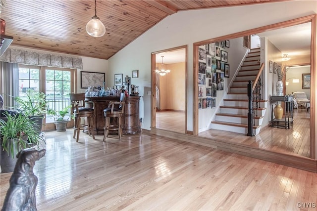 1 Carol Dr, Adams, NY 13605 - interior space with hardwood / wood-style flooring, stairs, vaulted ceiling, a chandelier, and a bar
