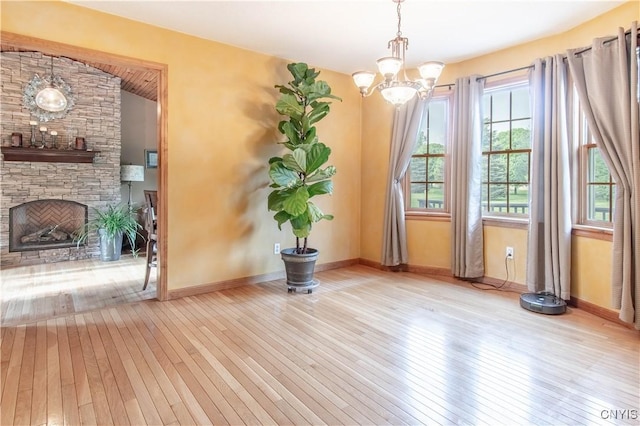 1 Carol Dr, Adams, NY 13605 - unfurnished dining area with wood-type flooring, a chandelier, a fireplace, and vaulted ceiling