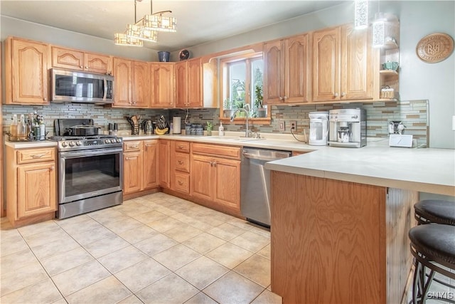 1 Carol Dr, Adams, NY 13605 - kitchen featuring stainless steel appliances, backsplash, a peninsula, a kitchen breakfast bar, and light countertops