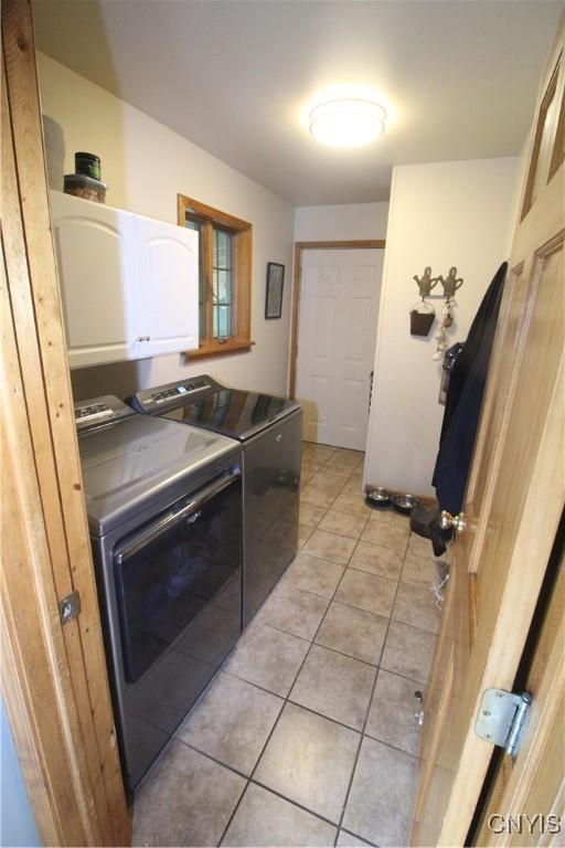 1 Carol Dr, Adams, NY 13605 - laundry room featuring cabinet space, independent washer and dryer, and light tile patterned flooring