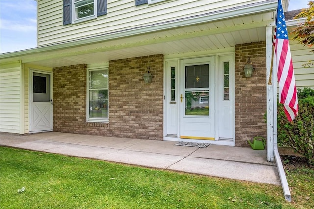 75 Red Rock Cir, Greece, NY 14626 - view of exterior entry featuring a porch and brick siding
