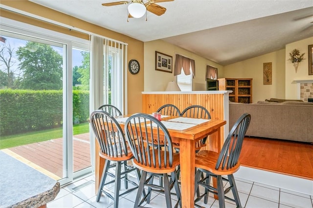75 Red Rock Cir, Greece, NY 14626 - dining space with ceiling fan, light tile patterned floors, and lofted ceiling