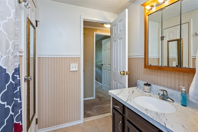 75 Red Rock Cir, Greece, NY 14626 - bathroom featuring wainscoting, vanity, baseboards, and tile patterned flooring