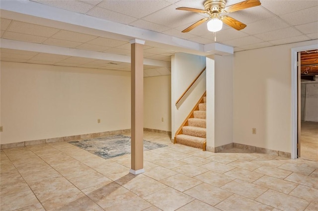 75 Red Rock Cir, Greece, NY 14626 - finished below grade area with a drop ceiling, stairway, tile patterned flooring, a ceiling fan, and baseboards