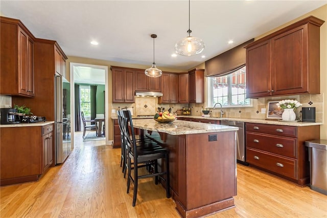 6305 Candlelight Run, Victor, NY 14564 - kitchen featuring stainless steel appliances, under cabinet range hood, healthy amount of natural light, light wood-type flooring, and recessed lighting