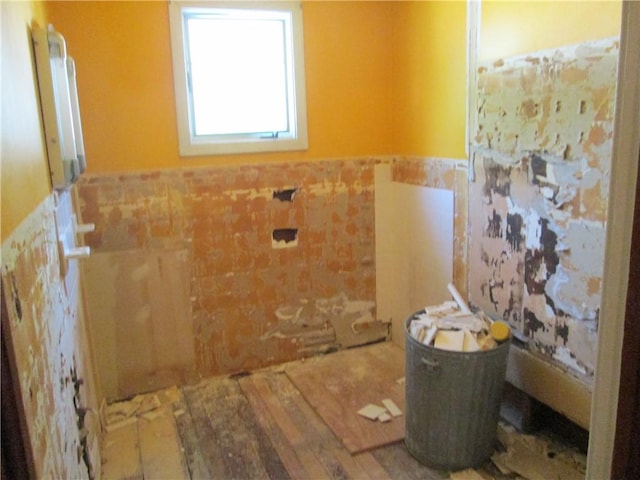 95 Wadsworth Ave, Avon, NY 14414 - bathroom with wainscoting, tile walls, and wood finished floors