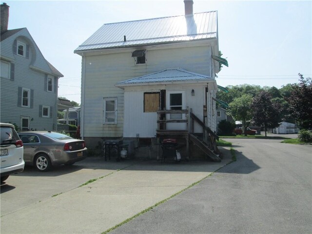 95 Wadsworth Ave, Avon, NY 14414 - rear view of property with a chimney and a metal roof