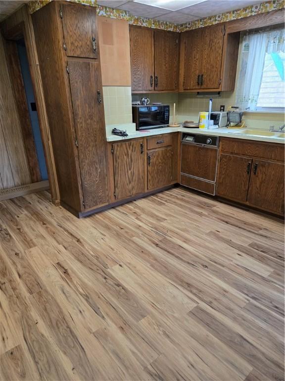 95 Wadsworth Ave, Avon, NY 14414 - kitchen with dishwasher, black microwave, light wood finished floors, and light countertops