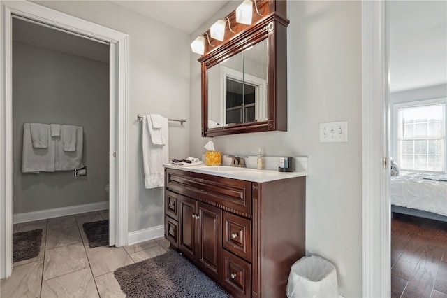 102 Trolley Line Rd, Hartwick, NY 13326 - bathroom with vanity, ensuite bath, baseboards, and toilet
