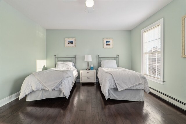 102 Trolley Line Rd, Hartwick, NY 13326 - bedroom with a baseboard heating unit, wood finished floors, and baseboards