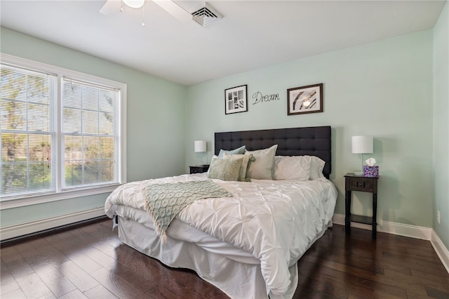 102 Trolley Line Rd, Hartwick, NY 13326 - bedroom with multiple windows, a baseboard radiator, dark wood-style flooring, and baseboards