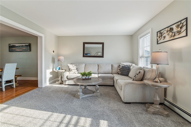 102 Trolley Line Rd, Hartwick, NY 13326 - carpeted living room with baseboard heating, baseboards, and wood finished floors