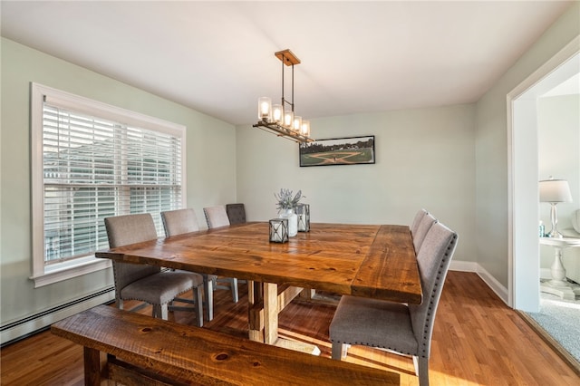 102 Trolley Line Rd, Hartwick, NY 13326 - dining area featuring light wood-style flooring, baseboard heating, baseboards, and a chandelier