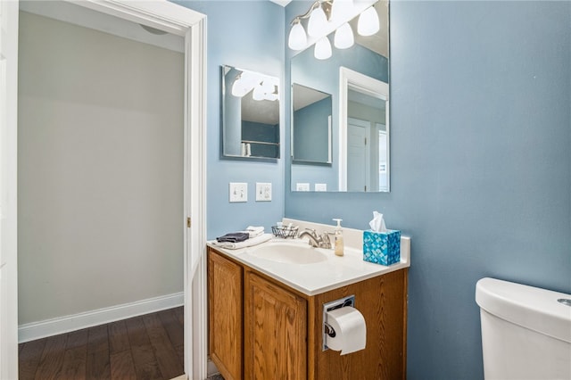 102 Trolley Line Rd, Hartwick, NY 13326 - bathroom with toilet, wood finished floors, vanity, and baseboards