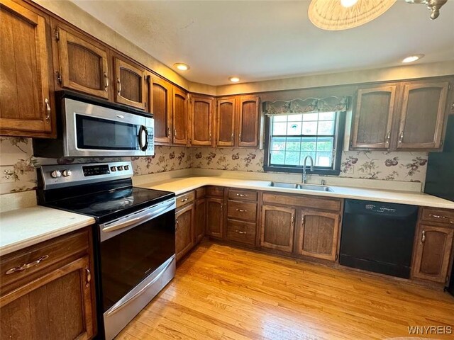 80 Capen Blvd, Amherst, NY 14226 - kitchen with appliances with stainless steel finishes, a sink, light countertops, and light wood-type flooring