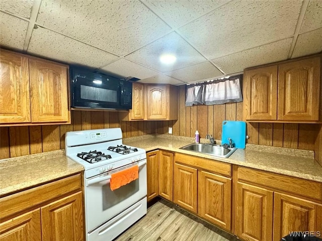 80 Capen Blvd, Amherst, NY 14226 - kitchen with white gas range oven, a sink, a drop ceiling, black microwave, and brown cabinetry