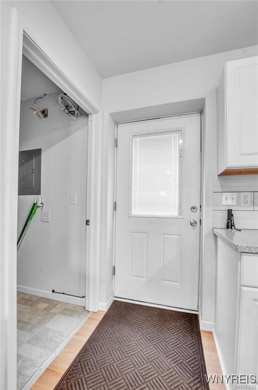 1806 Como Park Blvd, Lancaster, NY 14086 - doorway to outside with electric panel and light wood-style floors