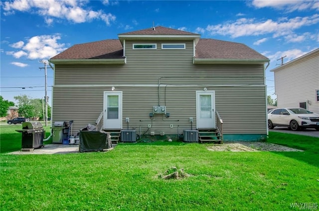 1806 Como Park Blvd, Lancaster, NY 14086 - rear view of property with entry steps, a lawn, and central AC unit