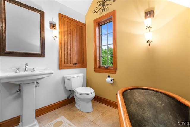 55 Redmond Rd, Trenton, NY 13304 - bathroom featuring baseboards, toilet, tile patterned floors, and lofted ceiling