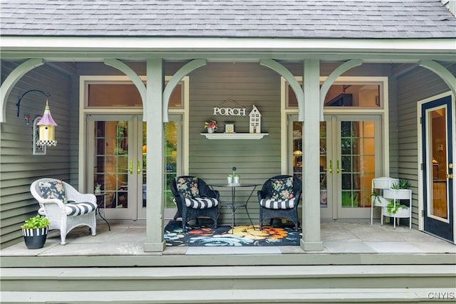 55 Redmond Rd, Trenton, NY 13304 - property entrance featuring a shingled roof, covered porch, and french doors