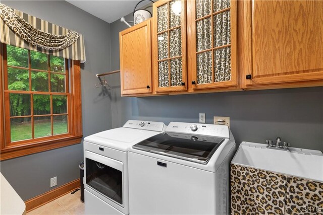 55 Redmond Rd, Trenton, NY 13304 - laundry room featuring washer and dryer, cabinet space, and light tile patterned floors