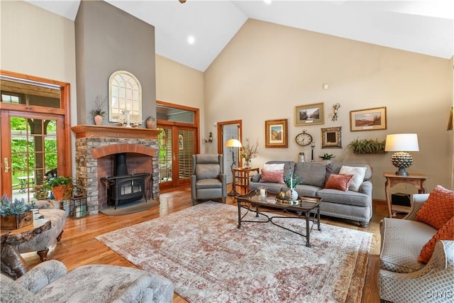 55 Redmond Rd, Trenton, NY 13304 - living area with high vaulted ceiling, a wood stove, wood finished floors, and french doors
