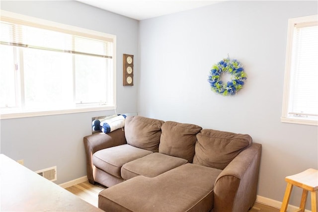 179 Kentucky Xing, Greece, NY 14612 - living area with healthy amount of natural light, baseboards, and light wood finished floors