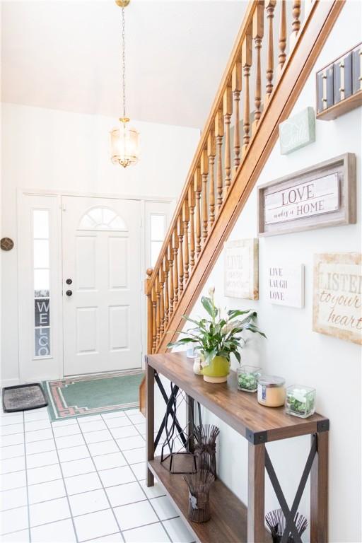 179 Kentucky Xing, Greece, NY 14612 - foyer entrance featuring stairway, a chandelier, and tile patterned flooring
