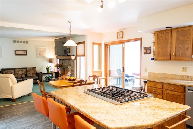 179 Kentucky Xing, Greece, NY 14612 - kitchen with appliances with stainless steel finishes, open floor plan, wood finished floors, pendant lighting, and light stone counters