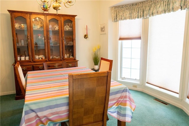 179 Kentucky Xing, Greece, NY 14612 - carpeted dining space featuring a chandelier and baseboards