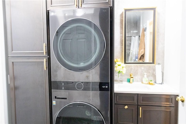 179 Kentucky Xing, Greece, NY 14612 - laundry area with estacked washer and dryer and cabinet space