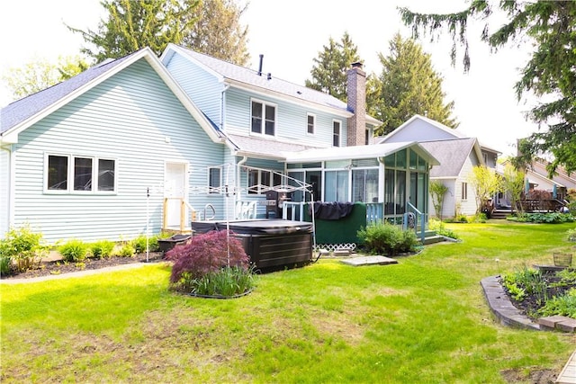 179 Kentucky Xing, Greece, NY 14612 - rear view of house with a hot tub, a sunroom, a chimney, a lawn, and roof with shingles