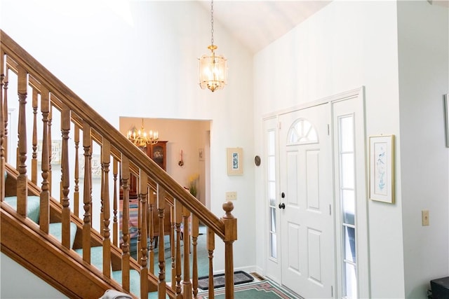 179 Kentucky Xing, Greece, NY 14612 - foyer with a chandelier, high vaulted ceiling, stairs, and baseboards